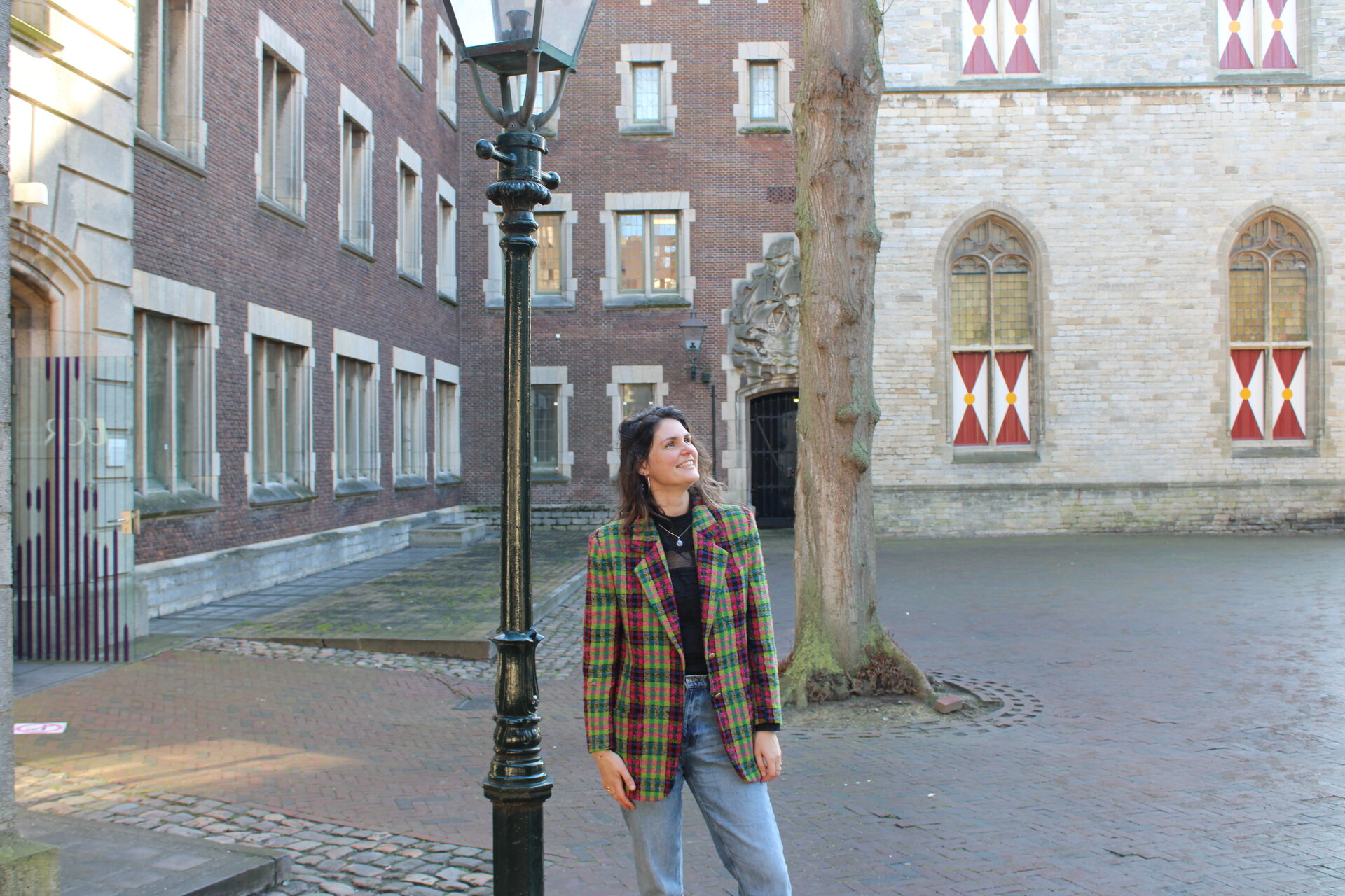 Gabriëlle looks up on an old market square